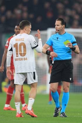 5th November 2024; Anfield, Liverpool, Merseyside, England; Champions League Football, Liverpool versus Bayer Leverkusen; Florian Wirtz of Bayer Leverkeusen is shown a yellow card by referee Danny Makkelie  ActionPlus12712509 DavidxBlunsden