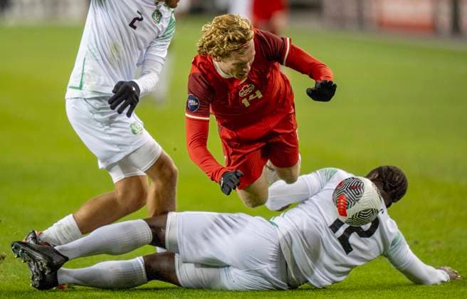 November 19, 2024, Toronto, On, CANADA: Canada forward Jacob Shaffelburg (14) is tackled hard by Suriname defender Leo Abena (12) in CONCACAF Nations League action in Toronto, Tuesday, Nov. 19, 2024. Canada News - November 19, 2024  - ZUMAc35_ 20241119_zaf_c35_144 Copyright: xFrankxGunnx