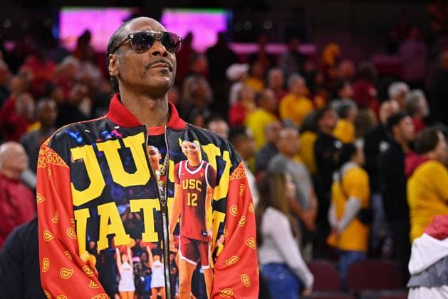 LOS ANGELES, CA - NOVEMBER 23: Rapper Snoop Dogg looks on during the national anthem, wearing a USC Trojans guard JuJu Watkins (12) jacket, before the women s college basketball game between the Notre Dame Fighting Irish and the USC Trojans on November 23, 2024 at Galen Center in Los Angeles, CA. (Photo by Brian Rothmuller Icon Sportswire) COLLEGE BASKETBALL: NOV 23 Women s - Notre Dame at USC EDITORIAL USE ONLY Icon241123030