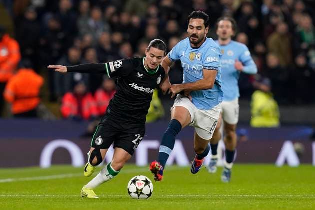 Manchester, England, 26th November 2024. Anis Hadj Moussa of Feyenoord and Ä°lkay Gundogan of Manchester City challenge for the ball during the UEFA Champions League match at the Etihad Stadium, Manchester. Picture credit should read: Andrew Yates Sportimage EDITORIAL USE ONLY. No use with unauthorised audio, video, data, fixture lists, club league logos or live services. Online in-match use limited to 120 images, no video emulation. No use in betting, games or single club league player publications. SPI-3484-0020