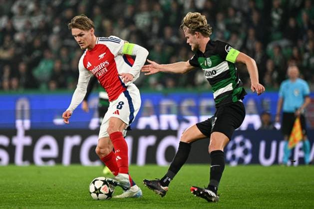 Martin odegaard of Arsenal under pressure from Morten Hjulmand of Sporting CP Sporting Lisbon v Arsenal, UEFA Champions League, Group Stage, Football, Estadio Jose Alvalade, Lisbon, Portugal - 26 Nov 2024 EDITORIAL USE ONLY No use with unauthorised audio, video, data, fixture lists, club league logos or live services. Online in-match use limited to 120 images, no video emulation. No use in betting, games or single club league player publications. Copyright: xZedxJameson Shutterstockx 14940177bo