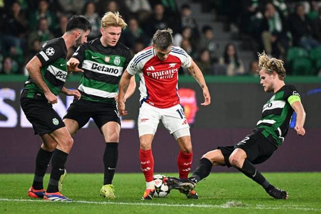 Leandro Trossard of Arsenal is tackled by Morten Hjulmand of Sporting CP Sporting Lisbon v Arsenal, UEFA Champions League, Group Stage, Football, Estadio Jose Alvalade, Lisbon, Portugal - 26 Nov 2024 EDITORIAL USE ONLY No use with unauthorised audio, video, data, fixture lists, club league logos or live services. Online in-match use limited to 120 images, no video emulation. No use in betting, games or single club league player publications.  Copyright: xZedxJameson Shutterstockx 14940177fh
