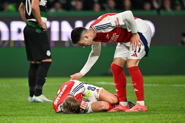 Martin odegaard of Arsenal reacts on the ground after winning a penalty for their side Sporting Lisbon v Arsenal, UEFA Champions League, Group Stage, Football, Estadio Jose Alvalade, Lisbon, Portugal - 26 Nov 2024 EDITORIAL USE ONLY No use with unauthorised audio, video, data, fixture lists, club league logos or live services. Online in-match use limited to 120 images, no video emulation. No use in betting, games or single club league player publications.  Copyright: xZedxJameson Shutterstockx 14940177ge