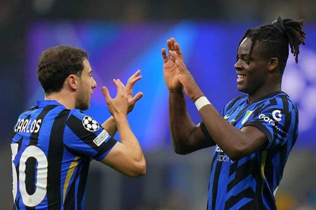 Inter Milan s Yann Aurel Bisseck , Inter Milan s Carlos Augusto celebrate winning the match after the Uefa Champions League soccer match between Inter and Leipzig at the San Siro Stadium in Milan, north Italy - Tuesday , November 26 , 2024. - Soccer .  Copyright: xSpada LaPressex