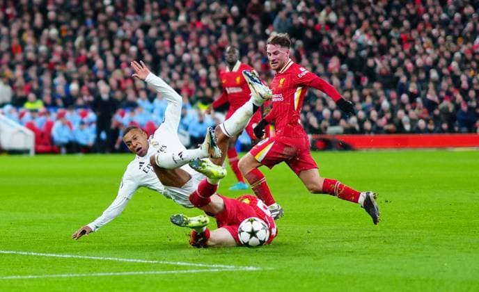 Conor Bradley of Liverpool times a superb tackle to deny Kylian Mbappà of Real Madrid Liverpool v Real Madrid, UEFA Champions League, Group Stage, Football, Anfield, Liverpool, UK - 27 Nov 2024 EDITORIAL USE ONLY No use with unauthorised audio, video, data, fixture lists, club league logos or live services. Online in-match use limited to 120 images, no video emulation. No use in betting, games or single club league player publications. Copyright: xJavierxGarcia Shutterstockx 14945029ah