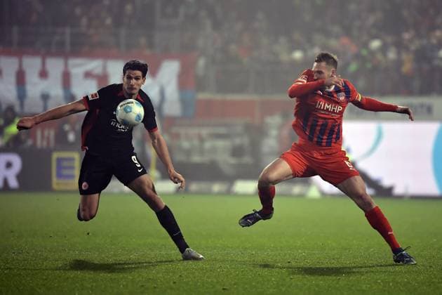 01.12.2024, xemx, Fussball 1.Bundesliga, 1.FC Heidenheim - Eintracht Frankfurt emspor, v.l. Igor Matanovic (Eintracht Frankfurt) Patrick Mainka (1.FC Heidenheim) Zweikampf, Aktion, action, battle for the ball (DFL DFB REGULATIONS PROHIBIT ANY USE OF PHOTOGRAPHS as IMAGE SEQUENCES and or QUASI-VIDEO) Heidenheim
