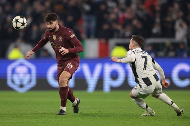 Turin, Italy, 11th December 2024. Josko Gvardiol of Manchester City heads away from Francisco Conceicao of Juventus during the UEFA Champions League match at Juventus Stadium, Turin. Picture credit should read: Jonathan Moscrop Sportimage EDITORIAL USE ONLY. No use with unauthorised audio, video, data, fixture lists, club league logos or live services. Online in-match use limited to 120 images, no video emulation. No use in betting, games or single club league player publications. SPI-3517-0064