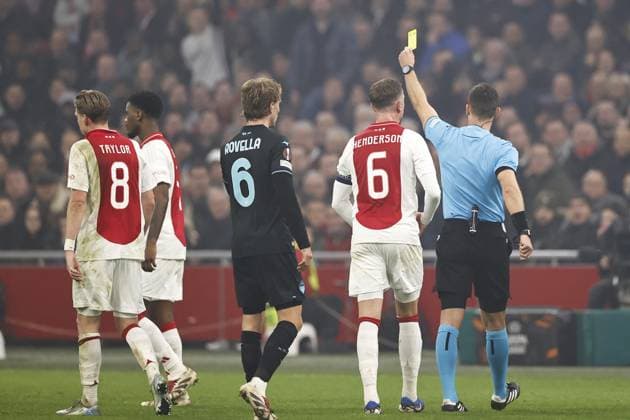 AMSTERDAM - (l-r) Jorrel Hato of Ajax, receives yellow card from referee Ivan Kruzliak during the UEFA Europa League match between AFC Ajax Amsterdam and SS Lazio Roma at the Johan Cruijff ArenA on Dec. 12, 2024 in Amsterdam, Netherlands. ANP Hollandse Hoogte MAURICE VAN STEEN UEFA Europa League 2024 25 League Phase MD6 2024 25 xVIxANPxSportx xMauricexvanxSteenxIVx 515559517 originalFilename: 515559517.jpg