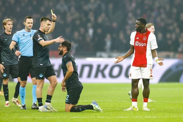 AMSTERDAM, 12-12-2024 , JohanCruyff Arena, Europa League Football, Ajax - Lazio Roma. Ajax player Brian Brobbey get a yellow card from referee Ivan Kruzliak Ajax - Lazio Roma  x27002273x Copyright: