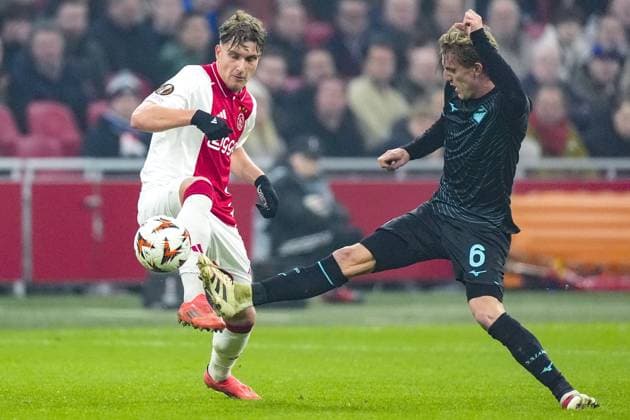 AMSTERDAM, 12-12-2024 , JohanCruyff Arena, Europa League Football, Ajax - Lazio Roma. Ajax player Mika Godts and Lazio Roma player Nicolo Rovella Ajax - Lazio Roma  x27002300x Copyright: