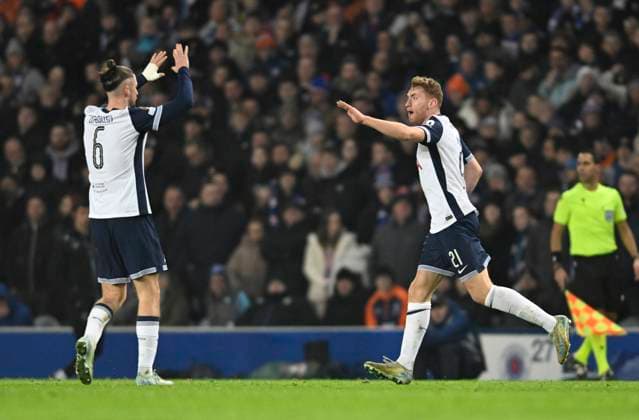 Glasgow, Scotland, 12th December 2024. Radu DrÄƒguÈ™in of Tottenham Hotspur celebrates with goal scorer Dejan Kulusevski of Tottenham Hotspur during the UEFA Europa League match at Ibrox Stadium, Glasgow. Picture credit should read: Neil Hanna Sportimage EDITORIAL USE ONLY. No use with unauthorised audio, video, data, fixture lists, club league logos or live services. Online in-match use limited to 120 images, no video emulation. No use in betting, games or single club league player publications. SPI-3523-0047