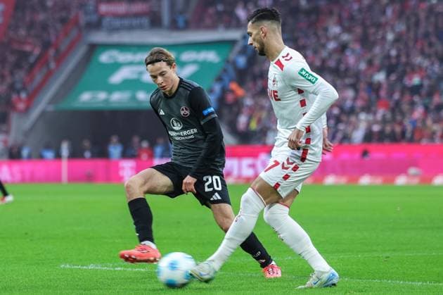 Fußball 2. Bundesliga 16. Spieltag 1. FC Köln - 1. FC Nürnberg am 15.12.2024 im RheinEnergieStadion in Köln Caspar Jander ( Nürnberg ), links - Leart Pacarada ( Köln ), rechts DFL regulations prohibit any use of photographs as image sequences and or quasi-video.