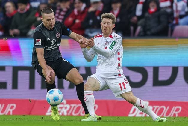 Fußball 2. Bundesliga 16. Spieltag 1. FC Köln - 1. FC Nürnberg am 15.12.2024 im RheinEnergieStadion in Köln Ondrej Karafiat ( Nürnberg ), links - Florian Kainz ( Köln ), rechts DFL regulations prohibit any use of photographs as image sequences and or quasi-video.