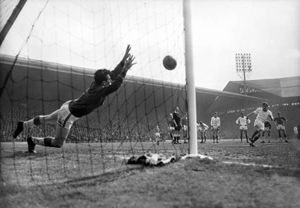 Football - 1963 1964 First Division - Liverpool 5 Arsenal 0 Arsenal s George Eastham sees his penalty kick saved by Tommy Lawrence at Anfield. Liverpool won the game to win the league title. 18 04 1964 