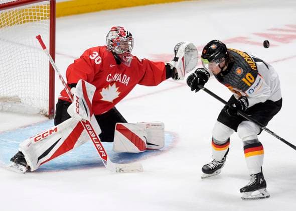 December 29, 2024, Ottawa, On, Canada: Germany forward Timo Ruckdaschel (10) attempts to screen Canada goaltender Carter George as he reaches for the puck during third period IIHF World Junior Hockey Championship tournament action in Ottawa, Sunday, Dec. 29, 2024. Carter George Timo Ruckdaschel  - ZUMAc35_ 20241229_zaf_c35_096 Copyright: xAdrianxWyldx