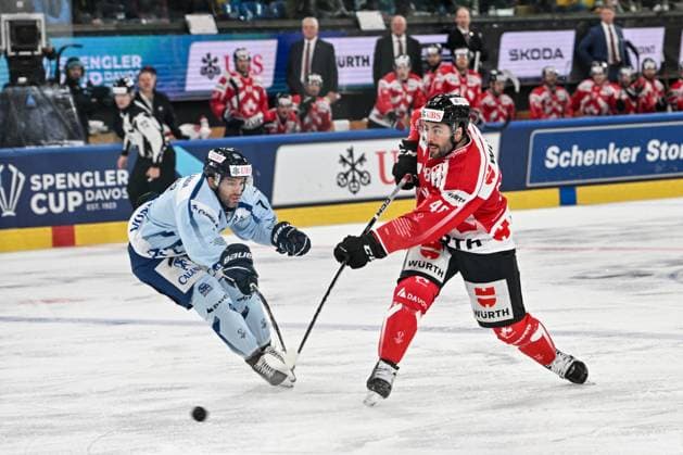 DAVOS, SWITZERLAND - DECEMBER 30: Jonathan Aspirot of Team Canada R) against Taylor Leier of Straubing Tigers L) during the Spengler Cup Davos Semifinals match between Team Canada and Straubing Tigers at Eisstadion Davos on December 30, 2024 in Davos, Switzerland. Davos Eisstadion Davos Graubunden Switzerland Copyright: xJustPictures.ch AndreaxBrancax jp-en-EuSpIm-SpenglerCup_Canada_01498