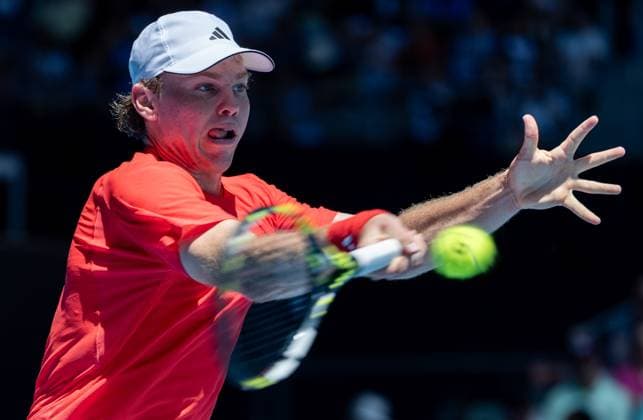 (250113) -- MELBOURNE, Jan. 13, 2025 -- Alex Michelsen hits a return during the men s singles first round match between Stefanos Tsitsipas of Greece and Alex Michelsen of the United States at Australian Open tennis tournament in Melbourne, Australia, Jan. 13, 2025. (Photo by Xinhua) (SP)AUSTRALIA-MELBOURNE-TENNIS-AUSTRALIAN OPEN-DAY 2 HuxJingchen 