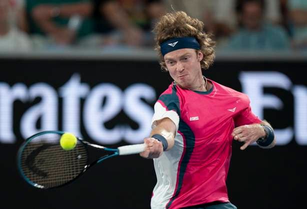 (250114) -- MELBOURNE, Jan. 14, 2025 -- Andrey Rublev hits a return during the men s singles first round match between Joao Fonseca of Brazil and Andrey Rublev of Russia at Australian Open tennis tournament in Melbourne, Australia, Jan. 14, 2025. ) (SP)AUSTRALIA-MELBOURNE-TENNIS-AUSTRALIAN OPEN LuixSiuxWai 