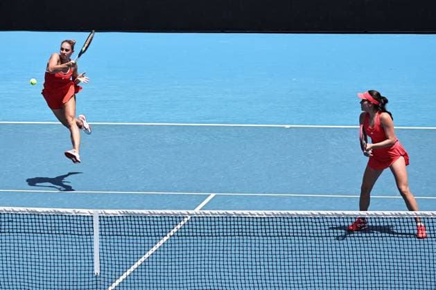 Marta Kostyuk (blonde hair), UKR, and Elena-Gabriela Ruse (red cap), ROU, during womenÂ s doubles at 2025 Australian Open in Melbourne, 19 01 2025; -