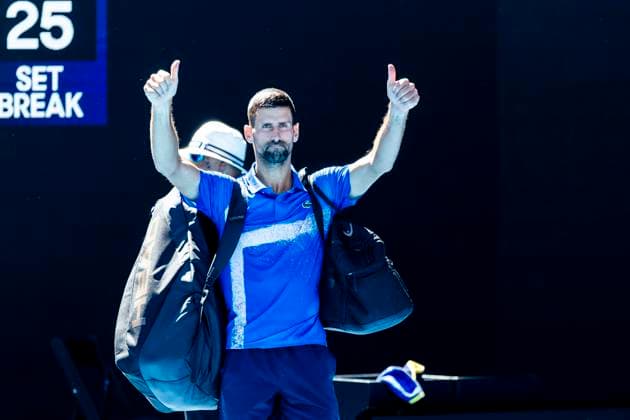 MELBOURNE, VIC - JANUARY 24: Novak Djokovic of Serbia gives thumbs up to the crowd after his retirement due to injury in his match during the Semifinals of the 2025 Australian Open on January 24 2025, at Melbourne Park in Melbourne, Australia. (Photo by Jason Heidrich Icon Sportswire) TENNIS: JAN 24 Australian Open EDITORIAL USE ONLY Icon250124073