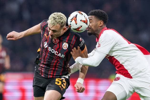 2025-01-30 AFC Ajax v Galatasaray - UEFA Europa League 2024 25 League Phase MD8 AMSTERDAM, NETHERLANDS - JANUARY 30: Baris Alper Yilmaz of Galatasaray AS heads the ball with Jorrel Hato of AFC Ajax during the UEFA Europa League 2024 25 League Phase MD8 match between AFC Ajax and Galatasaray at Johan Cruijff ArenA on January 30, 2025 in Amsterdam, Netherlands. Amsterdam Johan Cruijff ArenA Netherlands Content not available for redistribution in The Netherlands directly or indirectly through any third parties. Copyright: xBenxGalx
