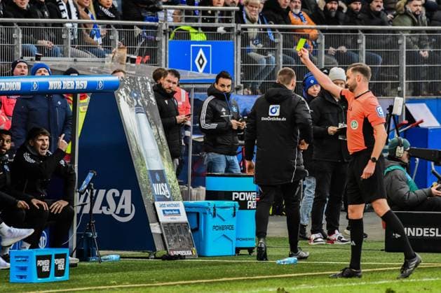 Schiedsrichter Michael Bacher zeigt der Bank bzw Athletiktrainer Jan Hasenkamp ( HSV nicht im Bild ) die Gelbe Karte Deutschland , Hamburg , Volksparkstadion , Fussball , 2 . Bundesliga , Hamburger SV - Hannover 96