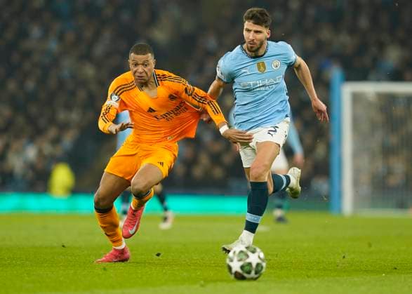Manchester, England, 11th February 2025. Manchester City s Ruben Dias with Real Madrid s Kylian Mbappe during the UEFA Champions League match at the Etihad Stadium, Manchester. Picture credit should read: Andrew Yates Sportimage EDITORIAL USE ONLY. No use with unauthorised audio, video, data, fixture lists, club league logos or live services. Online in-match use limited to 120 images, no video emulation. No use in betting, games or single club league player publications. SPI_AY_020_Man_City_Real_Madrid SPI-3675-0055