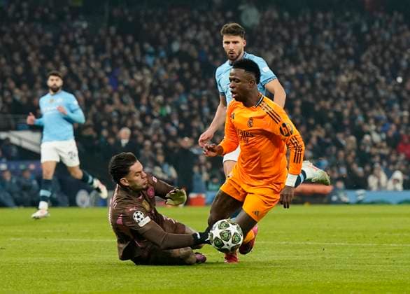 Manchester, England, 11th February 2025. Manchester City™s goalkeeper Ederson catches Real Madrid™s Vinicius Junior but he is offside during the UEFA Champions League match at the Etihad Stadium, Manchester. Picture credit should read: Andrew Yates Sportimage EDITORIAL USE ONLY. No use with unauthorised audio, video, data, fixture lists, club league logos or live services. Online in-match use limited to 120 images, no video emulation. No use in betting, games or single club league player publications. SPI_AY_022_Man_City_Real_Madrid SPI-3675-0057