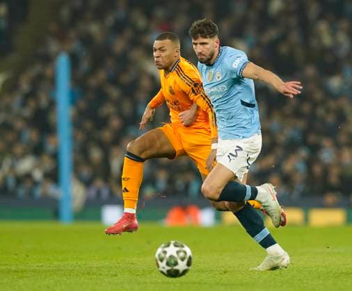 Manchester, England, 11th February 2025. Manchester City s Ruben Dias with Real Madrid s Kylian Mbappe during the UEFA Champions League match at the Etihad Stadium, Manchester. Picture credit should read: Andrew Yates Sportimage EDITORIAL USE ONLY. No use with unauthorised audio, video, data, fixture lists, club league logos or live services. Online in-match use limited to 120 images, no video emulation. No use in betting, games or single club league player publications. SPI_AY_025_Man_City_Real_Madrid SPI-3675-0060