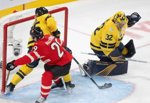 February 12, 2025, Montreal, Pq, CANADA: Sweden defenceman Rasmus Dahlin (26) clears the puck as Canada forward Nathan MacKinnon (29) looks for the rebound in front of goaltender Filip Gustavsson (32) during second period 4 Nations Face-Off hockey action in Montreal on Wednesday, Feb. 12, 2025. Canada News - February 12, 2025  - ZUMAc35_ 20250212_zaf_c35_135 Copyright: xChristinnexMuschix