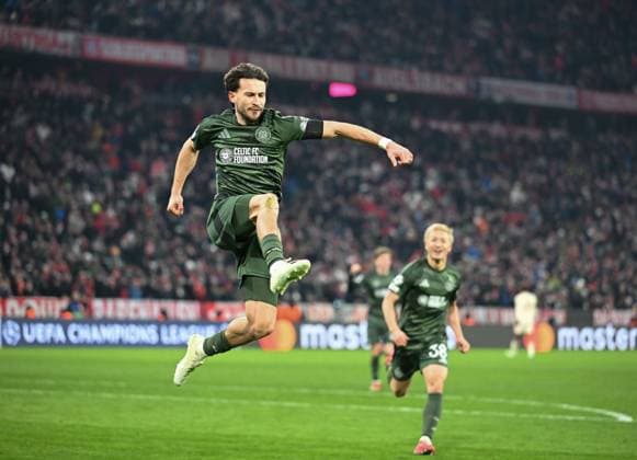 Nicolas Kuhn of Celtic celebrates scoring to give Celtic a 0-1 lead (Agg. 2-2), chased by team mate Daizen Maeda of Celtic. Bayern Munich v Celtic, UEFA Champions League, Knockout Round Play-offs, Second Leg, Football, Allianz Arena, Munich, Germany - 18 Feb 2025 Editorial use only  Copyright: xUlrichxGamel Shutterstockx 15156608at