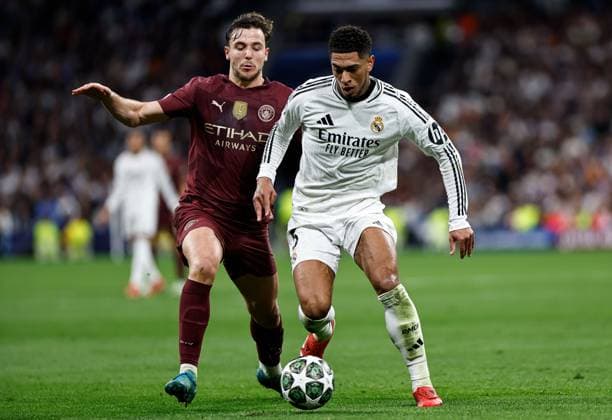 Nico of Manchester City battles with Jude Bellingham of Real Madrid Real Madrid v Manchester City, UEFA Champions League, Knockout Round Play-offs, Second Leg, Football, Santiago BernaboÆ?Ã?Æ?o Ã? u, Madrid, Spain - 19 Feb 2025 EDITORIAL USE ONLY No use with unauthorised audio, video, data, fixture lists, club league logos or live services. Online in-match use limited to 120 images, no video emulation. No use in betting, games or single club league player publications.  Copyright: xRubenxAlbarran Shutterstockx 15137179ag