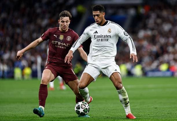 Nico of Manchester City battles with Jude Bellingham of Real Madrid Real Madrid v Manchester City, UEFA Champions League, Knockout Round Play-offs, Second Leg, Football, Santiago BernaboÆ?Ã?Æ?o Ã? u, Madrid, Spain - 19 Feb 2025 EDITORIAL USE ONLY No use with unauthorised audio, video, data, fixture lists, club league logos or live services. Online in-match use limited to 120 images, no video emulation. No use in betting, games or single club league player publications.  Copyright: xRubenxAlbarran Shutterstockx 15137179af