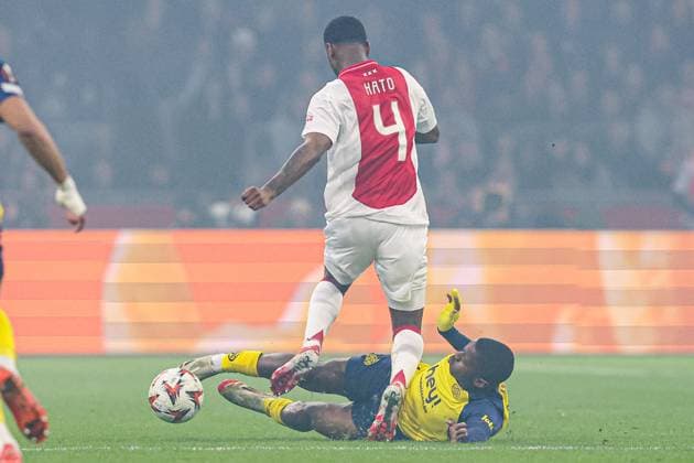 2025-02-20 AFC Ajax v R. Union Saint-Gilloise - UEFA Europa League 2024 25 League Knockout Play-off Second Leg AMSTERDAM, NETHERLANDS - FEBRUARY 20: Jorrel Hato of AFC Ajax gets tackled by Noah Sadiki of R. Union Saint-Gilloise during the UEFA Europa League 2024 25 League Knockout Play-off Second Leg match between AFC Ajax and R. Union Saint-Gilloise at Johan Cruijff Arena on February 20, 2025 in Amsterdam, Netherlands. Amsterdam Johan Cruijff Arena Netherlands Content not available for redistribution in The Netherlands directly or indirectly through any third parties. Copyright: xBenxGalx
