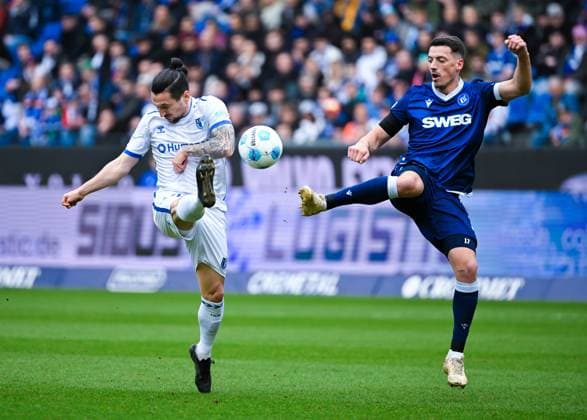 Baris Atik (1. FC Magdeburg) und Nicolai Rapp (Karlsruher SC) im Zweikampf waehrend des Spiels der 2. Bundesliga zwischen Karlsruher SC und 1. FC Magdeburg im BBBank Wildpark am 22. February 2025 in Karlsruhe, Deutschland. (Foto von Silas Schüller DeFodi Images) +++ Baris Atik (1. FC Magdeburg) and Nicolai Rapp (Karlsruher SC) battle for the ball during the 2. Bundesliga match between Karlsruher SC and 1. FC Magdeburg at BBBank Wildpark on February 22, 2025 in Karlsruhe, Germany. (Photo by Silas Schüller DeFodi Images) DFB DFL REGULATIONS PROHIBIT ANY USE OF PHOTOGRAPHS AS IMAGE SEQUENCES AND OR QUASI-VIDEO. (Photo by Silas Schueller DeFodi Images)