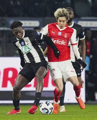 Football: French Cup Junya Ito (R) of Reims vies for the ball during a French Cup football quarterfinal match against Angers on Feb. 25, 2025, in Angers, France.  A14AA0004211887P