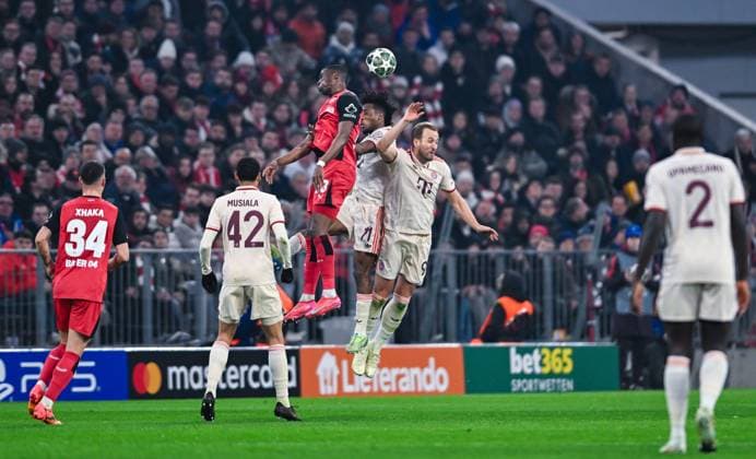 Nordi Mukiele (Bayer 04 Leverkusen), Kingsley Coman (FC Bayern Muenchen) and Harry Kane (FC Bayern Muenchen) battle for the ball during the UEFA Champions League 2024 25 Round of 16 First Leg match between FC Bayern München and Bayer 04 Leverkusen at Allianz Arena on March 5, 2025 in Munich, Germany. (Photo by Silas Schueller DeFodi Images)