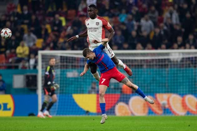 Thu 6 March, UEFA Europa League, Round of 16,1st leg, National Arena, Bucharest, FCSB vs LYON 19 Moussa NiakhatÃ climbs high and wins a header against 7 Florin Tanase