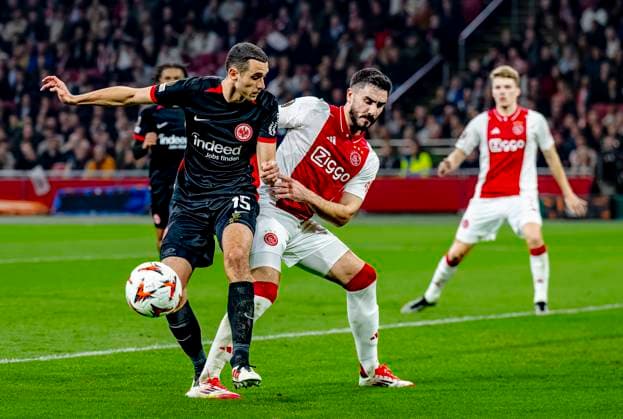 Eintracht Frankfurt midfielder Ellyes Skhiri, AFC Ajax Amsterdam defender Josip Sutalo during the match Ajax - Eintracht at the Johan Cruijff ArenA for the UEFA Europa League - Round of 16 - 1st leg season 2024-2025 in AMSTERDAM, Netherlands on 6 march 2025, (photo by Marcel van Dorst EYE4images DeFodi Images)