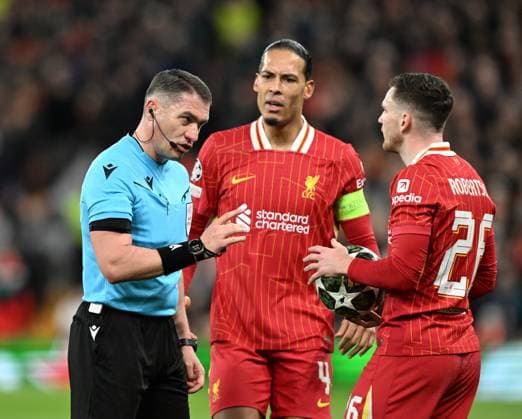 Liverpool, England, 11th March 2025. Referee Istvan Kovacs speaks to Andrew Robertson of Liverpool during the UEFA Champions League match Liverpool vs Paris Saint Germain at Anfield, Liverpool. Picture credit should read: Cody Froggatt Sportimage EDITORIAL USE ONLY. No use with unauthorised audio, video, data, fixture lists, club league logos or live services. Online in-match use limited to 120 images, no video emulation. No use in betting, games or single club league player publications. SPI_CF_043_Man_City_Real_Madrid SPI-3739-0043