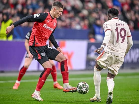Leverkusen, Germany, 11.03.2025: Patrick Schick (Bayer 04 Leverkusen) und Alphonso Davies (FC Bayern Muenchen) battle for the ball during the UEFA Champions League 2024 25 Round of 16 Second Leg match between Bayer 04 Leverkusen and FC Bayern München at BayArena on March 11, 2025 in Leverkusen, Germany. (Photo by Harry Langer DeFodi Images)