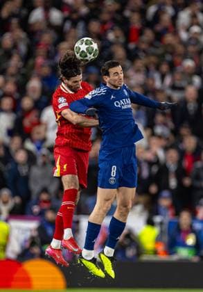 (250312) -- LIVERPOOL, March 12, 2025 -- Liverpool s Dominik Szoboszlai (L) challenges for a header with Paris Saint-Germain s Fabian Ruiz during the UEFA Champions League Round of 16 2nd Leg match between Liverpool FC and Paris Saint-Germain FC in Liverpool, Britain, on March 11, 2025. (SP)BRITAIN-LIVERPOOL-FOOTBALL-UEFA CHAMPIONS LEAGUE-LIVERPOOL FC VS PSG LixYing 