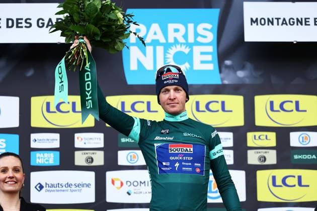 Belgian Tim Merlier of Soudal Quick-Step celebrates on the podium in the green jersey of leader in the sprint ranking after stage four of the 83th edition of the Paris-Nice cycling race, 163,4km from Vichy to La Loge des Gardes, France, Wednesday 12 March 2025. DAVIDxPINTENS  x114783777x