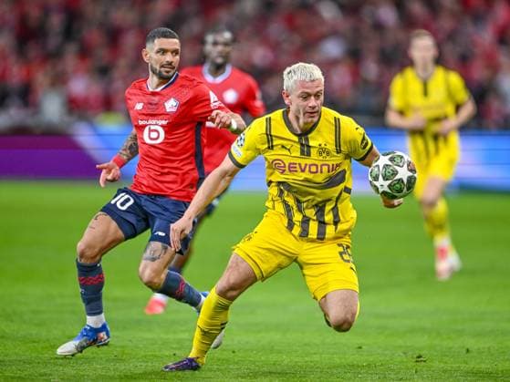 Lille, France, 12.03.2025: Remy Cabella (LOSC Lille) und Julian Ryerson (BV Borussia Dortmund) battle for the ball during the UEFA Champions League 2024 25 Round of 16 Second Leg match between LOSC Lille and Borussia Dortmund at Stade Pierre-Mauroy on March 12, 2025 in Lille, France. (Photo by Harry Langer DeFodi Images)