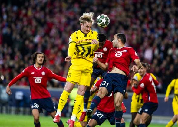 Lille, Stade Pierre Mauroy, 12.03.2025: Julian Brandt of Dortmund jumps for a header against Ismaily of Lille during the match of the Championsleague Round 16 between Lille OSC v. Borussia Dortmund.