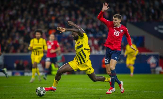 Lille, Germany. 12th Mar 2025. Serhou Guirassy (BvB) Thomas Meunier (Lille) OSC Lille - Borussia Dortmund 12.03.2025