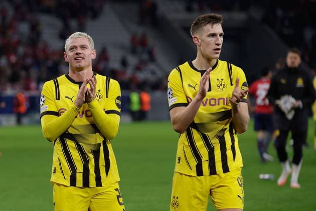 March 12, 2025, Villeneuve-D ascq, France, Julian Ryerson (Borussia Dortmund) and Nico Schlotterbeck (Borussia Dortmund)applauds the fans after the match the UEFA Champions League match between OSC Lille and Borussia Dortmund Copyright: AntonioxBorga