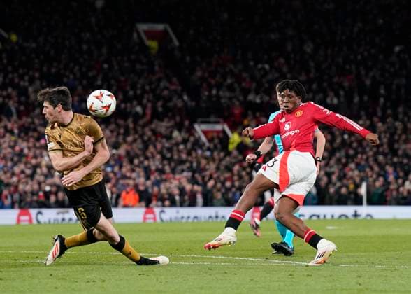 Manchester, England, 13th March 2025. Patrick Dorgu of Manchester United, ManU takes a shot on goal during the UEFA Europa League match Manchester United v Real Sociedad at Old Trafford, Manchester. Picture credit should read: Andrew Yates Sportimage EDITORIAL USE ONLY. No use with unauthorised audio, video, data, fixture lists, club league logos or live services. Online in-match use limited to 120 images, no video emulation. No use in betting, games or single club league player publications. SPI_049_AY_MANU_SOCIEDAD SPI-3744-0049