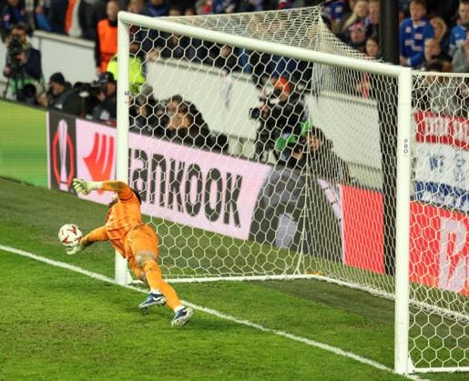 Jack Butland of Rangers saves a penalty from Fred of Fenerbahce in the penalty shootout during the UEFA Europa League round of 16 match at Ibrox Stadium, Glasgow. Rangers v Fenerbahce, UEFA Europa League, Round of 16, Second Leg, Football, Ibrox Stadium, Glasgow, Scotland, UK - 13 Mar 2025 EDITORIAL USE ONLY No use with unauthorised audio, video, data, fixture lists, club league logos or live services. Online in-match use limited to 120 images, no video emulation. No use in betting, games or single club league player publications.  Copyright: xRangersxFC Shutterstockx 15196581u