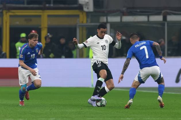 Milan, Italy, 20th March 2025. Jamal Musiala of Germany controls the ball as Nicolo Barella and Matteo Politano of Italy close in during the UEFA Nations League match at Giuseppe Meazza, Milan. Picture credit should read: Jonathan Moscrop Sportimage EDITORIAL USE ONLY. No use with unauthorised audio, video, data, fixture lists, club league logos or live services. Online in-match use limited to 120 images, no video emulation. No use in betting, games or single club league player publications. SPI_005_JM_ITALY_GERMANY_UNL_ SPI-3749-0005
